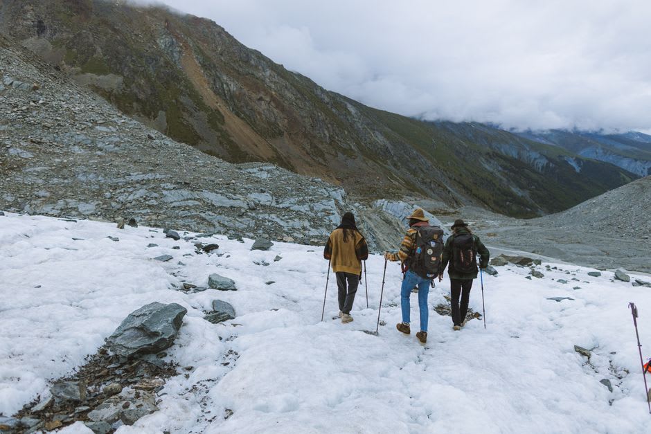Hikers crossing a windswept alpine pass on the Dientes de Navarino trek