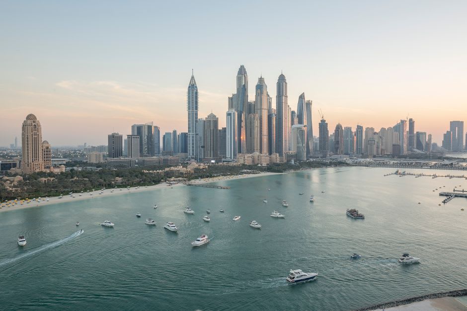 Panoramic view of the Dubai Marina coastline seen from inside an Ain Dubai capsule at sunset
