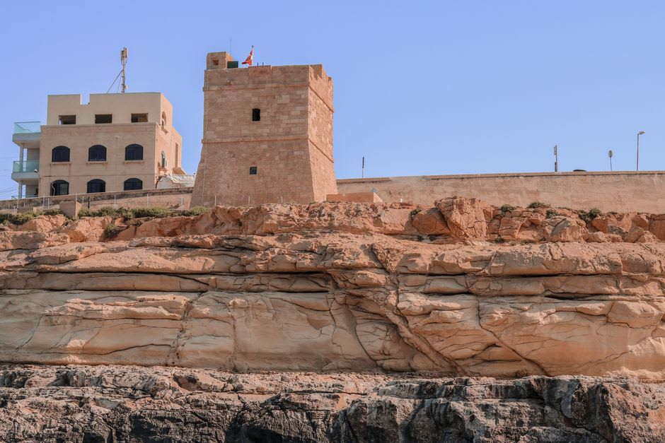 Old coral-stone watchtower and heritage buildings along the Umm Al Quwain waterfront