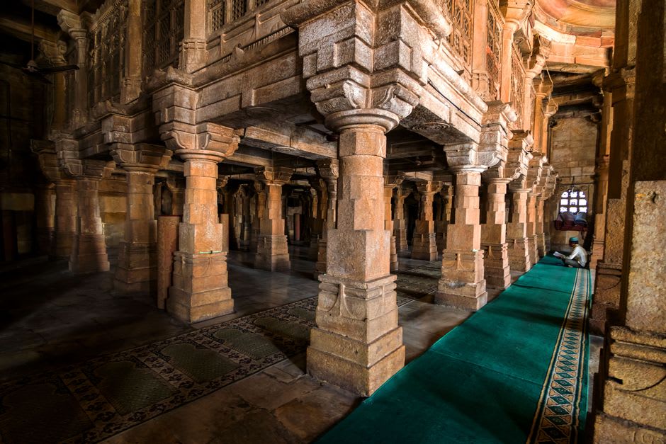 Wooden colonnade with dozens of carved pillars at Kokand's Jami Mosque