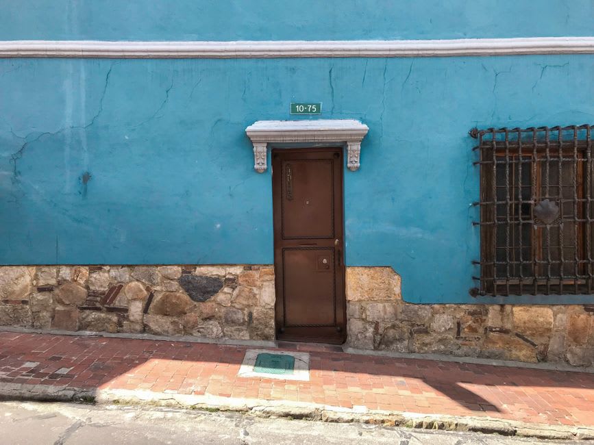 Carved wooden door on a whitewashed adobe house along Calle Zamora in Coro's historic center