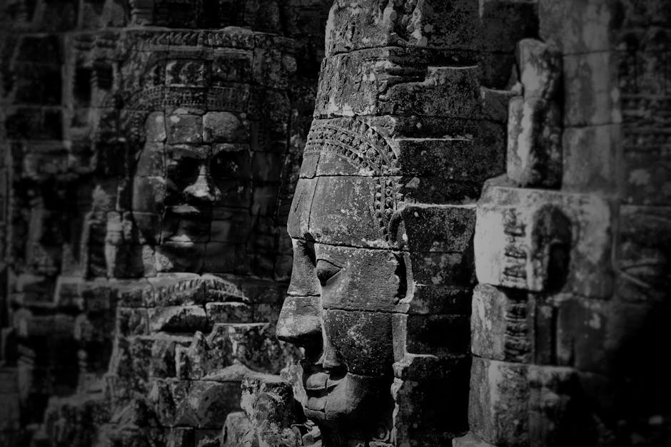 The serene stone faces of Bayon temple bathed in golden light