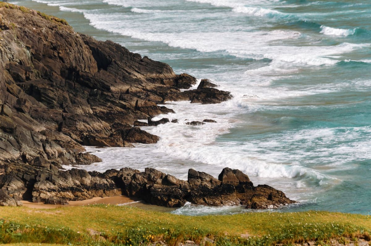 Dramatic cliffs along Ireland's Atlantic coast with waves crashing far below
