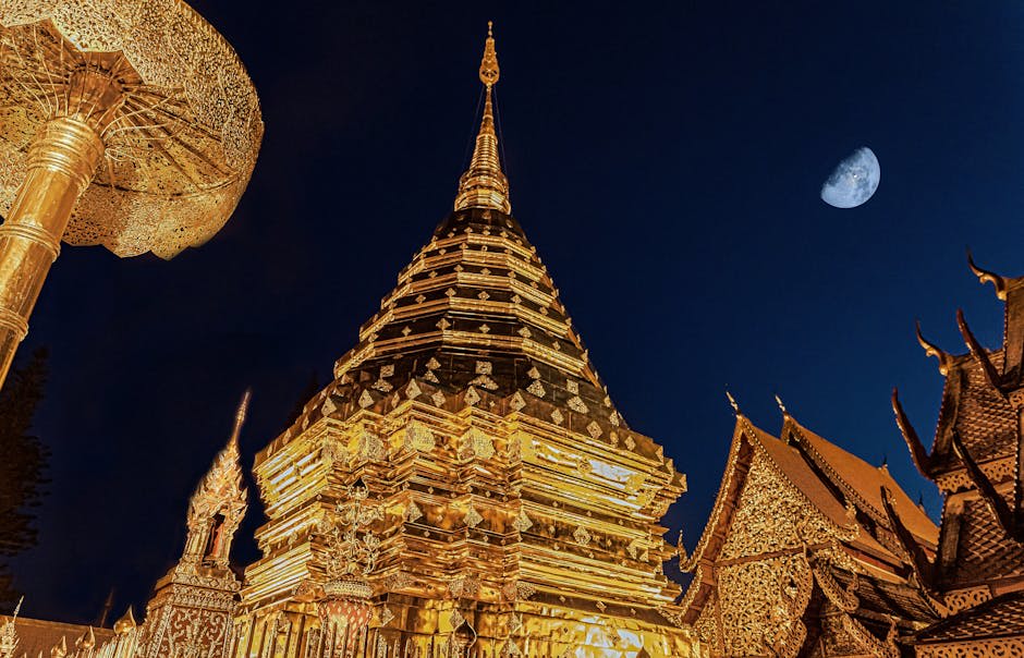 Golden temple spires catching the first light of dawn in Chiang Mai