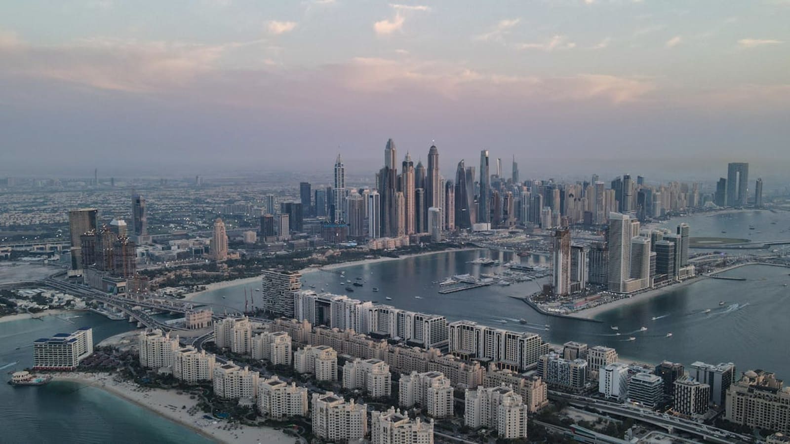 UAE travel guide with desert dunes and Abu Dhabi skyline at golden hour