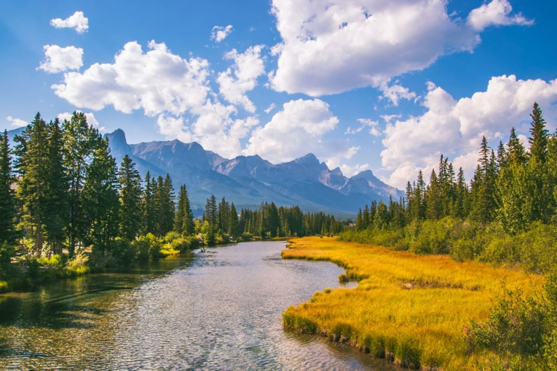 Mount Kidd and the Kananaskis Valley bathed in evening light, a turquoise river running through the valley floor