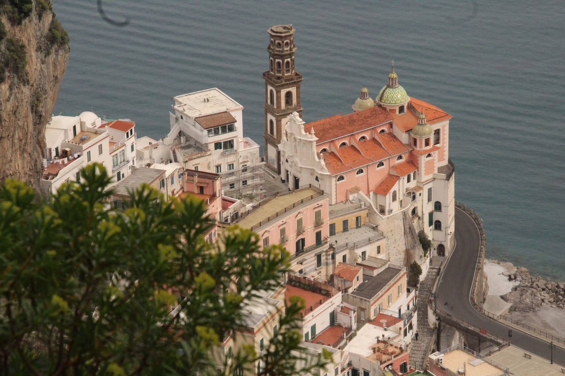 The tiny piazza of Atrani at the mouth of its sea gorge, with the church of San Salvatore and fishermen's houses crowding the small beach