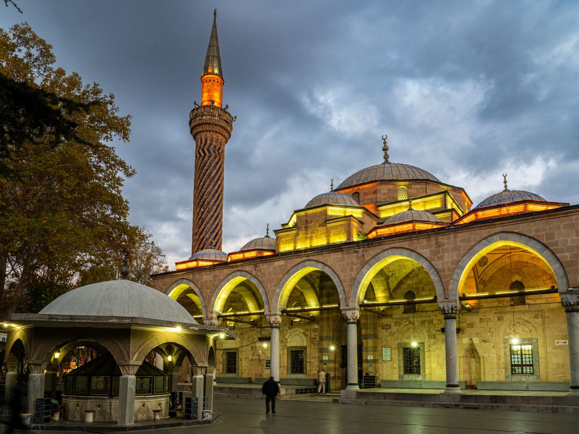 The turquoise-tiled dome of the Mevlâna Museum rising above the rooftops of Konya at dusk