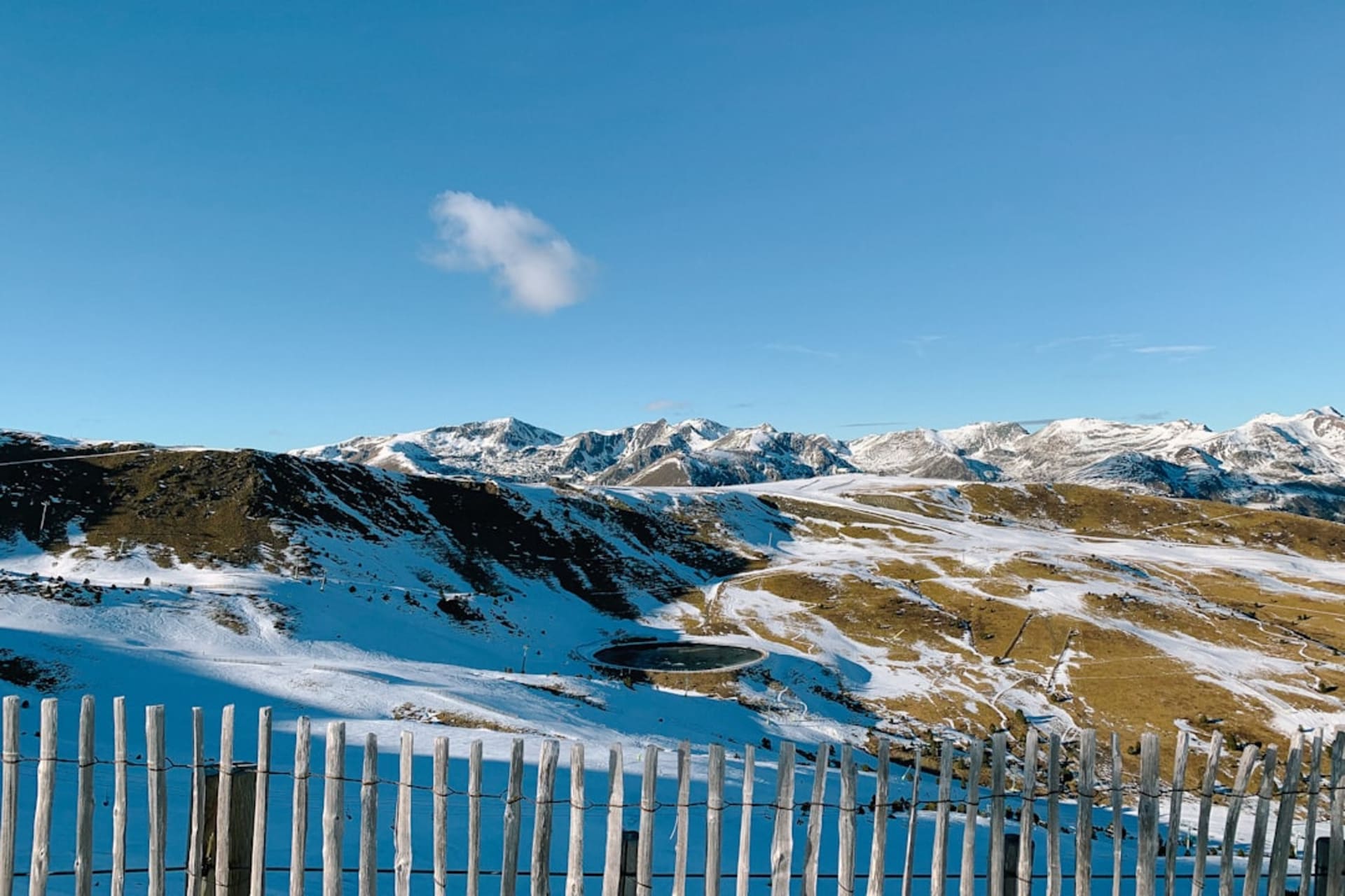 Snow-covered chalets and ski lifts rising above Soldeu village at dusk