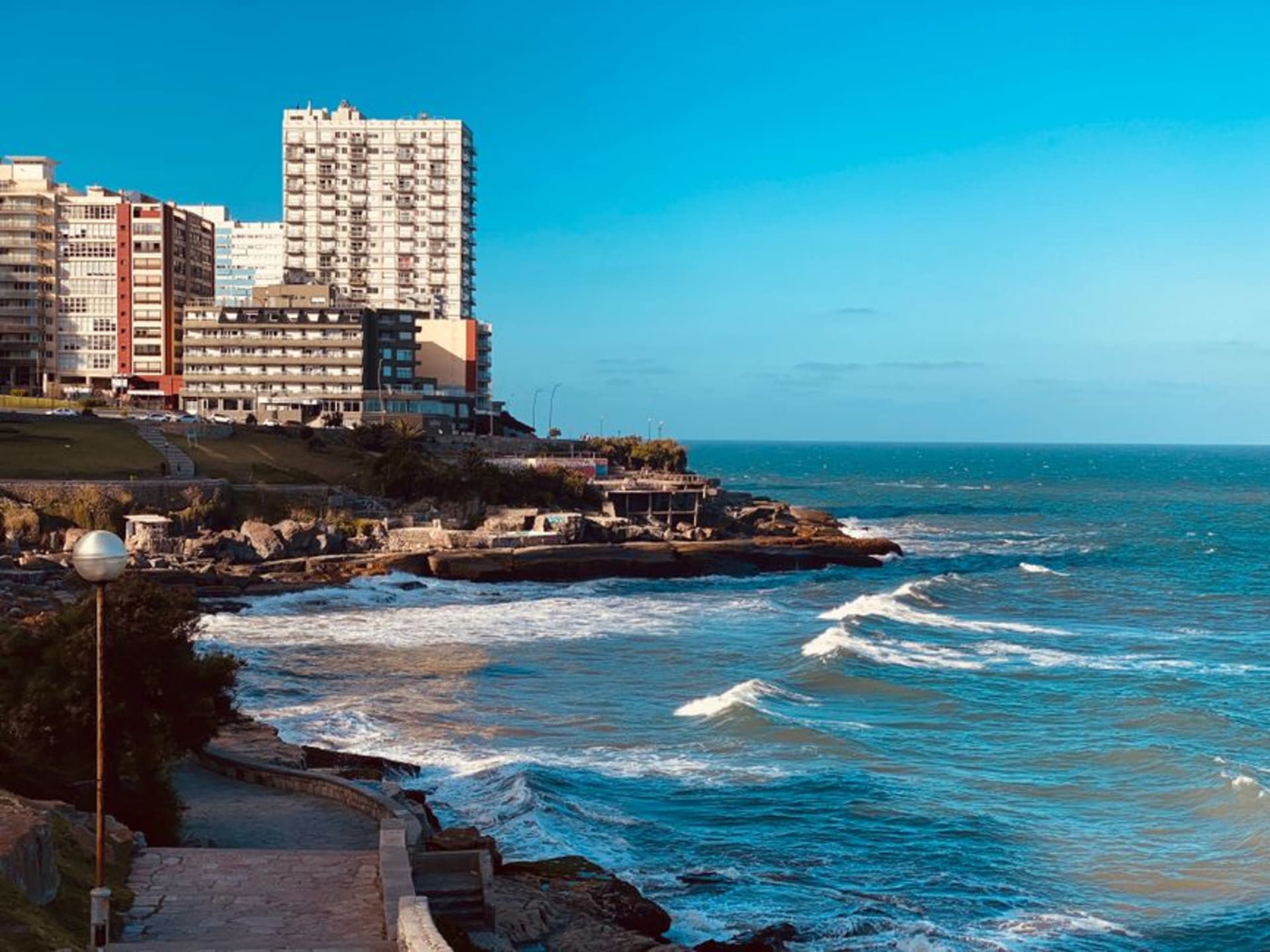 Crowded golden sand beach in Mar del Plata packed with striped umbrellas and beachgoers along the Atlantic coast