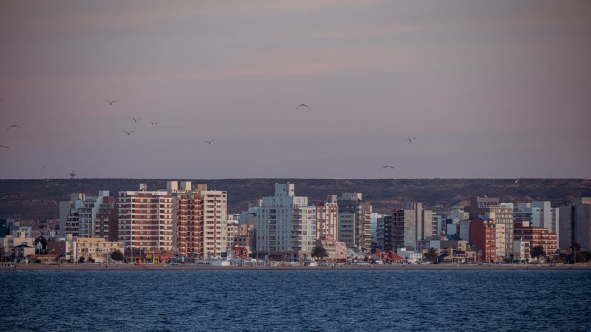 The waterfront promenade of Puerto Madryn at sunset with the calm waters of Golfo Nuevo