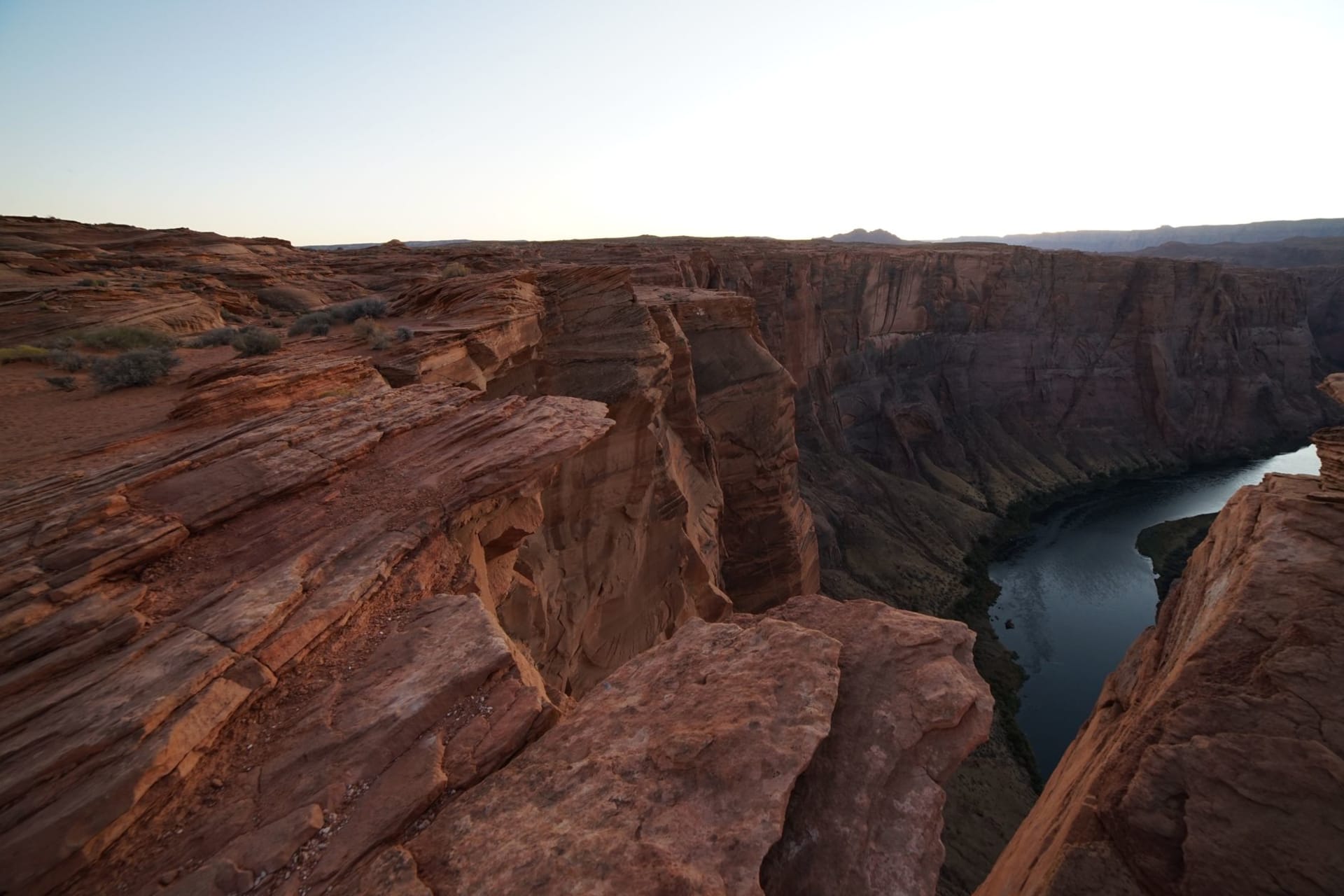Sunrise over red sandstone cliffs and the Colorado River deep in the Grand Canyon, Arizona