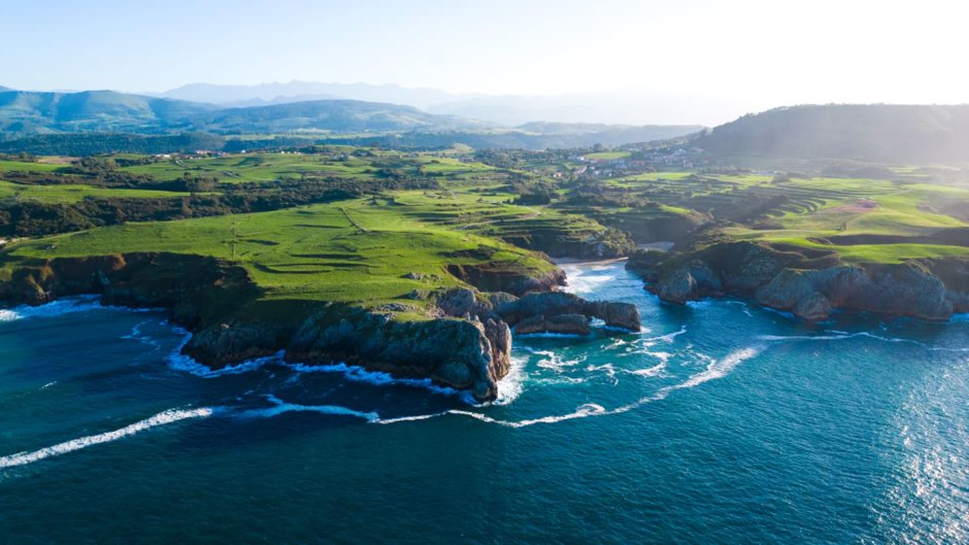 The lighthouse at Cabo de Peñas standing above the cliffs of the Cantabrian coast