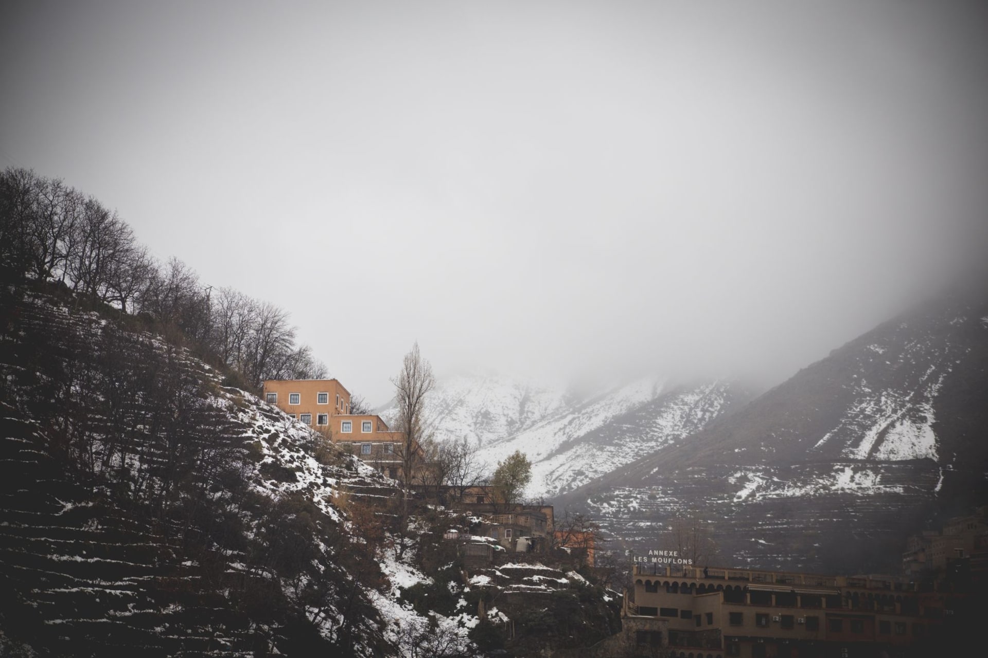 Moody winter landscape of Imlil village in the Atlas Mountains with snow-dusted peaks above