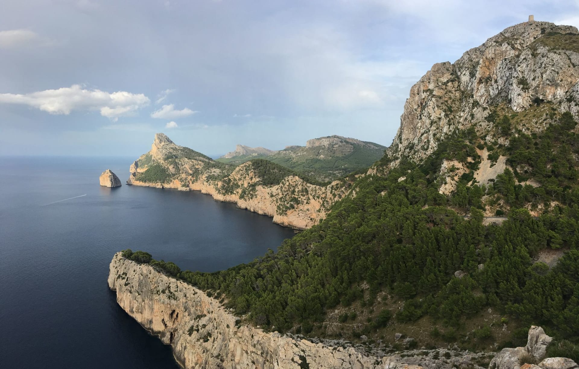 The lighthouse at Cap de Formentor perched on a limestone cliff above the deep blue Mediterranean