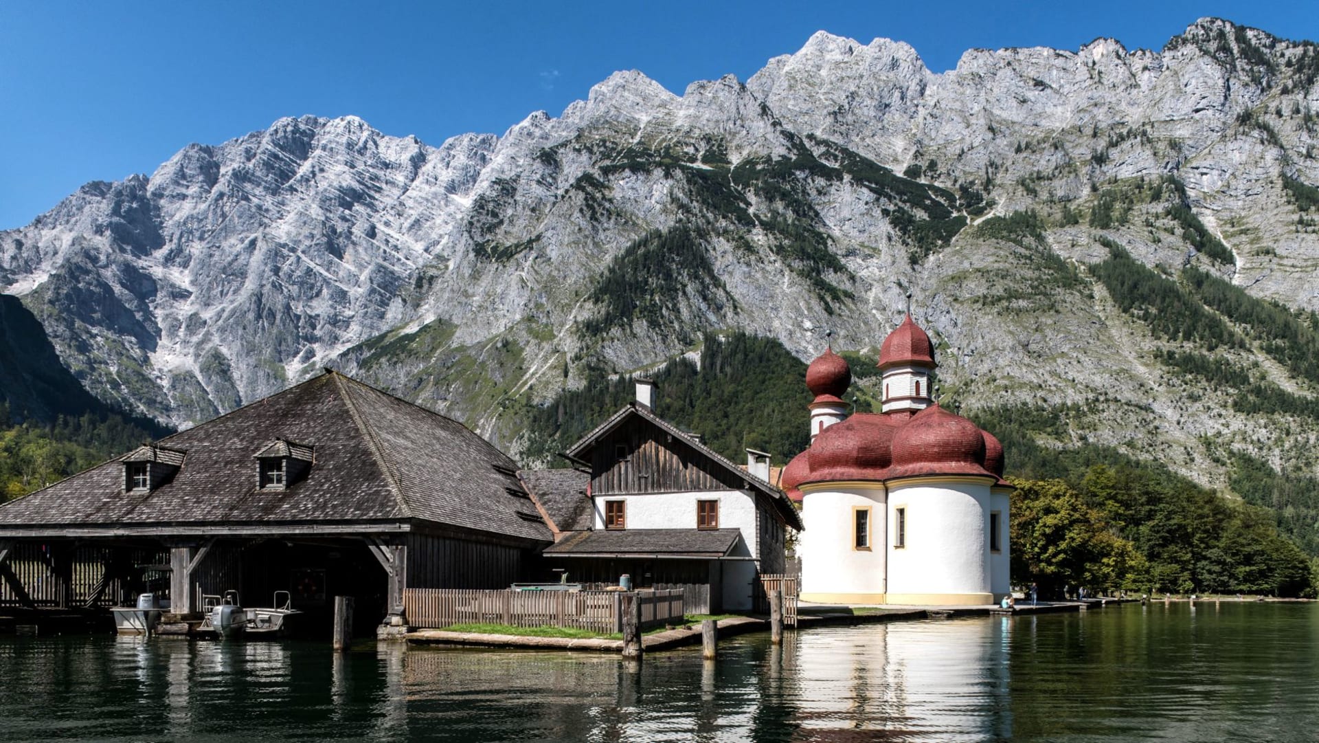 Königssee lake with St. Bartholomew's church on its wooded peninsula, Watzmann east face rising sheer above