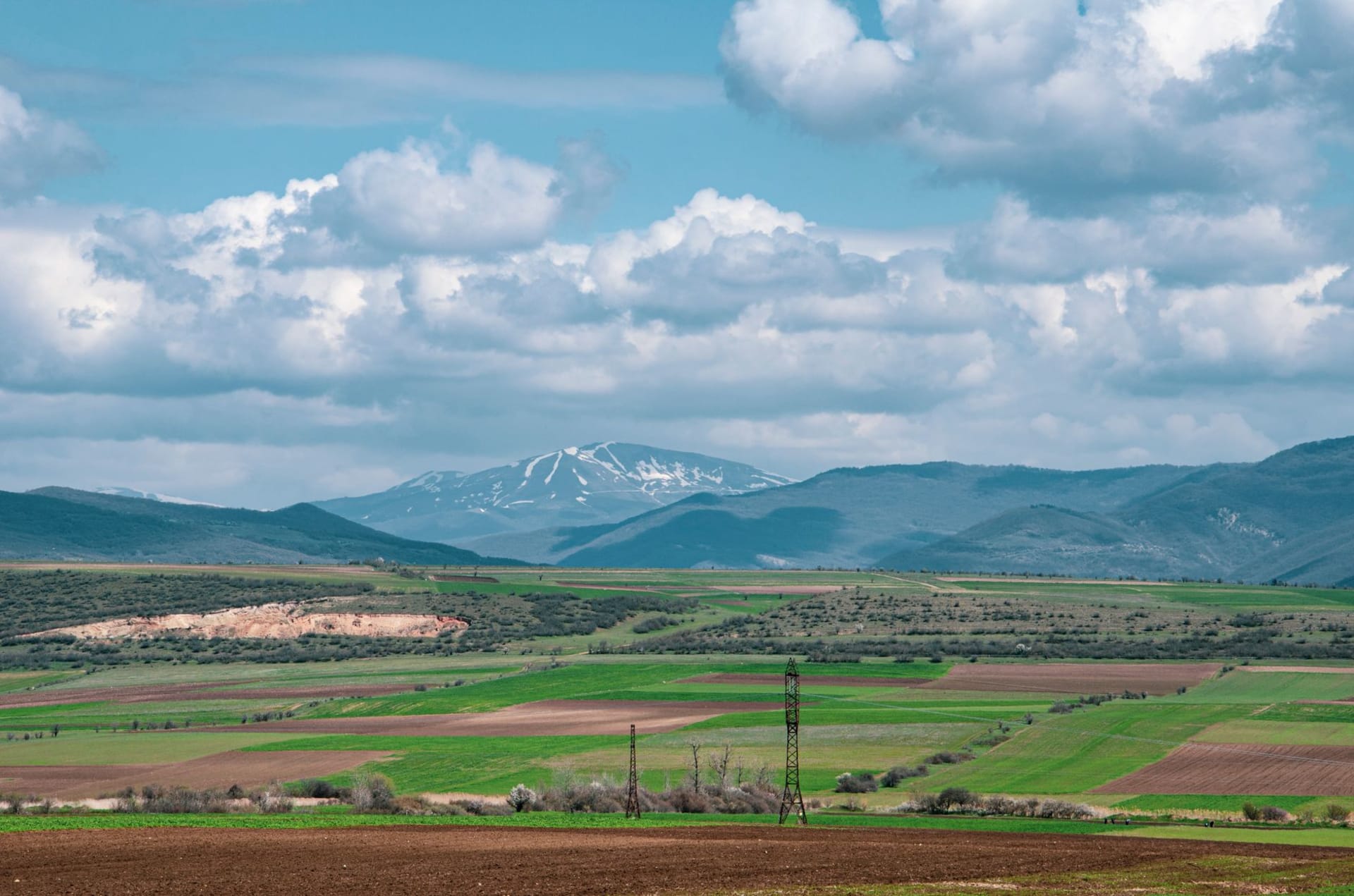 The high plateau of Yammouneh in Lebanon, with its sacred spring pool reflecting the bare mountain ridges above