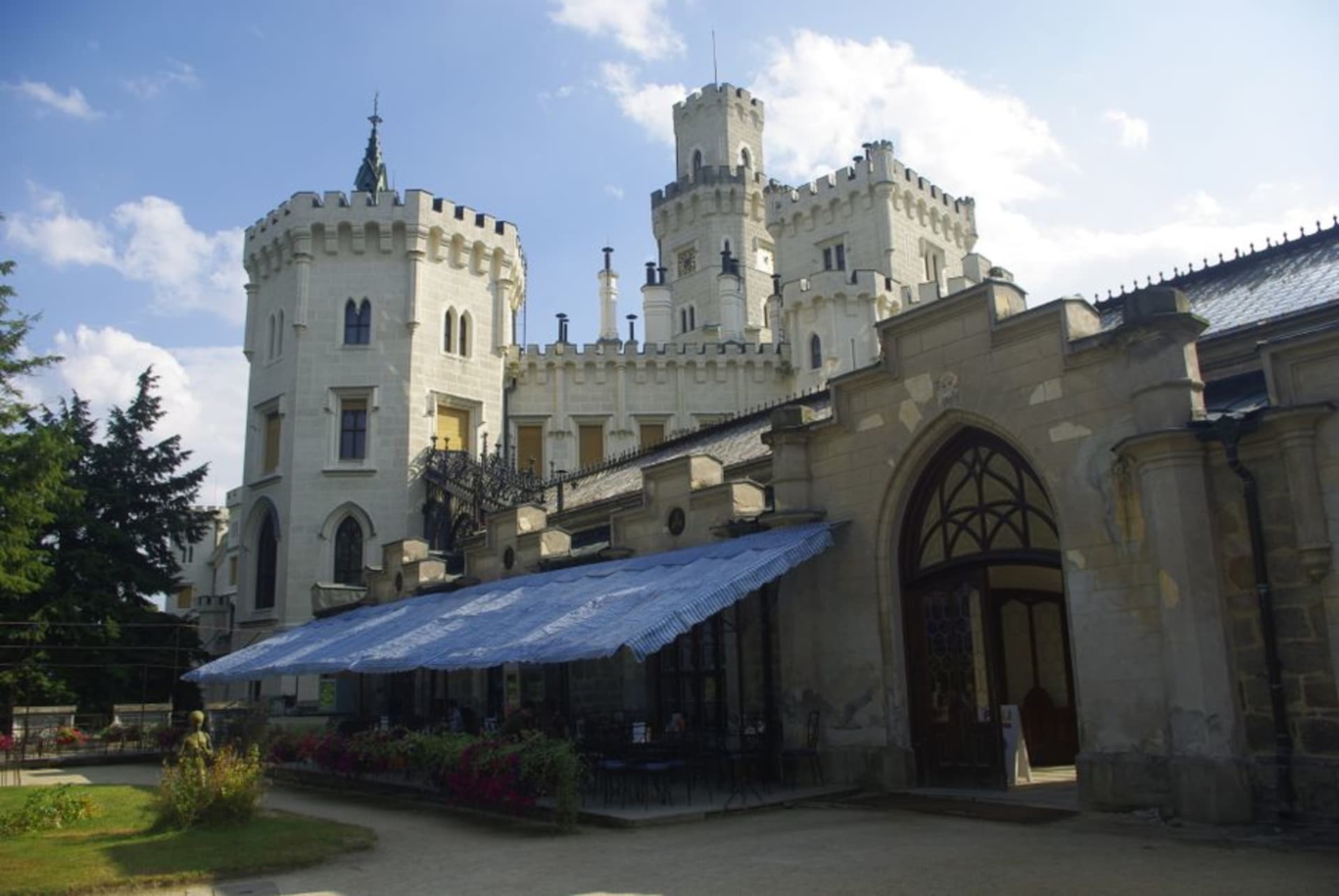 The white Neo-Gothic towers of Hluboká Castle rising above the Vltava River valley