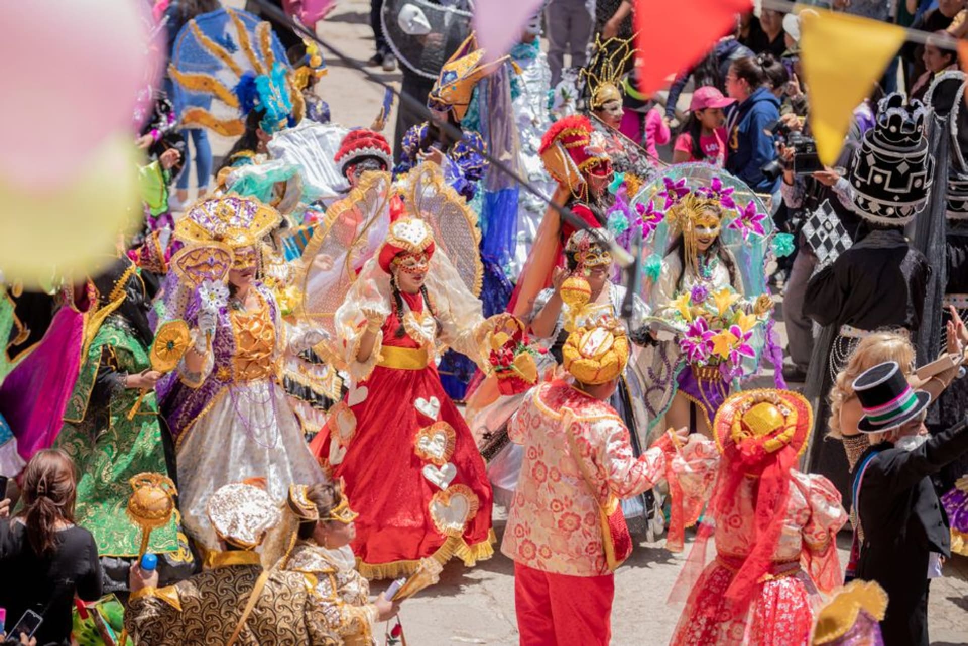 Diablada dancers in elaborate devil masks and costumes parading through the streets of Oruro during Carnaval