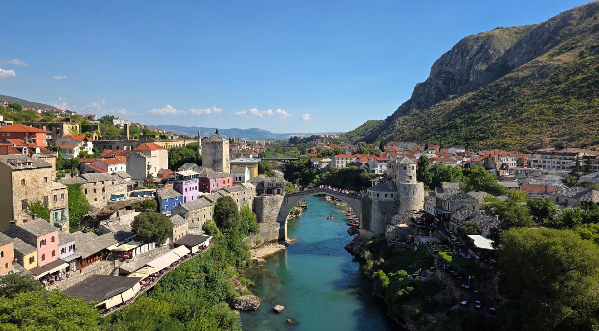 Počitelj's Ottoman stone houses and Hajji Alija mosque cascading down a steep limestone cliff above the wide Neretva river valley