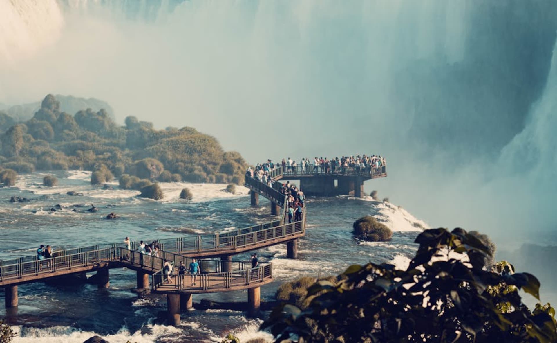 Panoramic view of Iguazu Falls with mist rising from the cascade