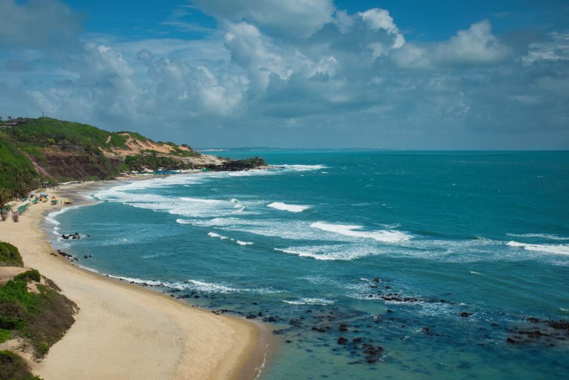 Cliffs and beaches of Praia do Amor in Pipa with turquoise water and green vegetation along the clifftop