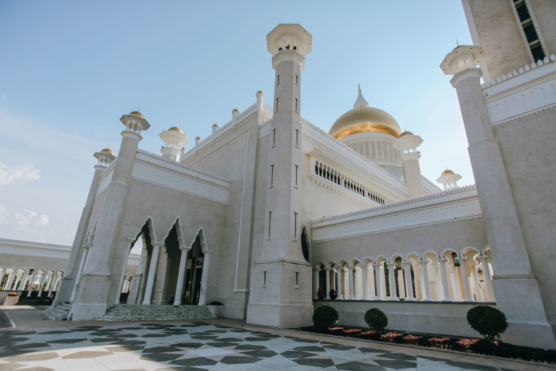 Wide view of Bandar Seri Begawan waterfront with the golden dome of Omar Ali Saifuddien Mosque rising above the city at dawn