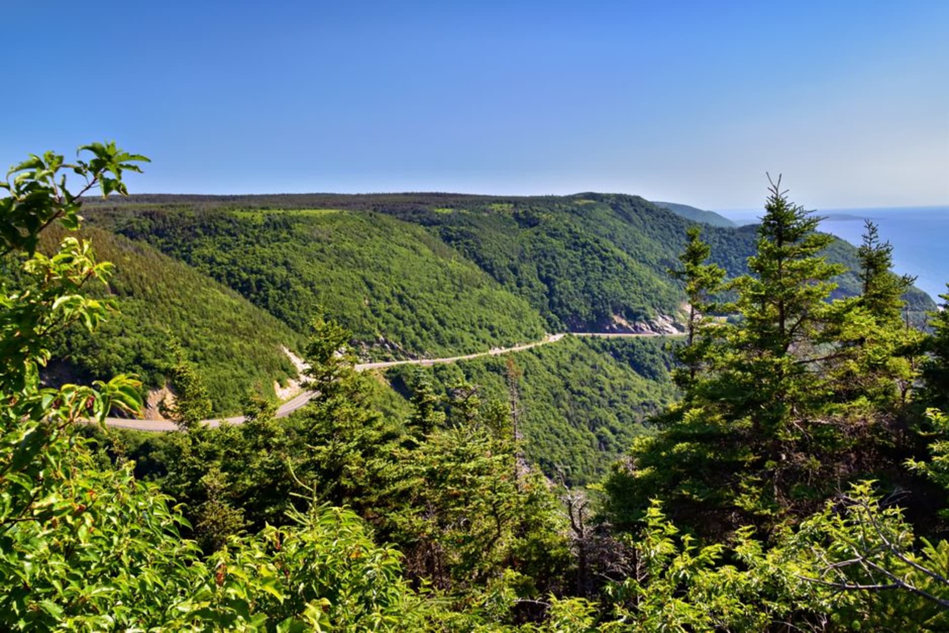 The Cabot Trail highway curving along steep coastal cliffs above the Gulf of St. Lawrence