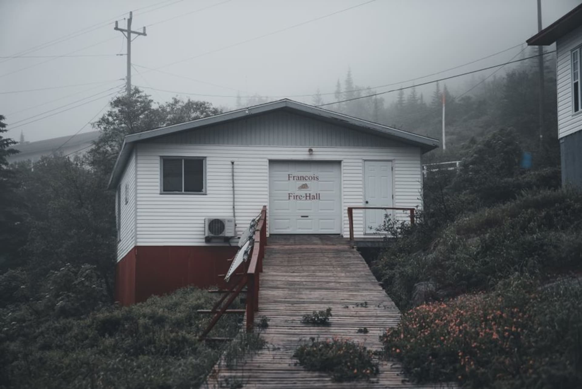 Colourful false-front wooden buildings and dirt streets of historic Dawson City with autumn hills behind