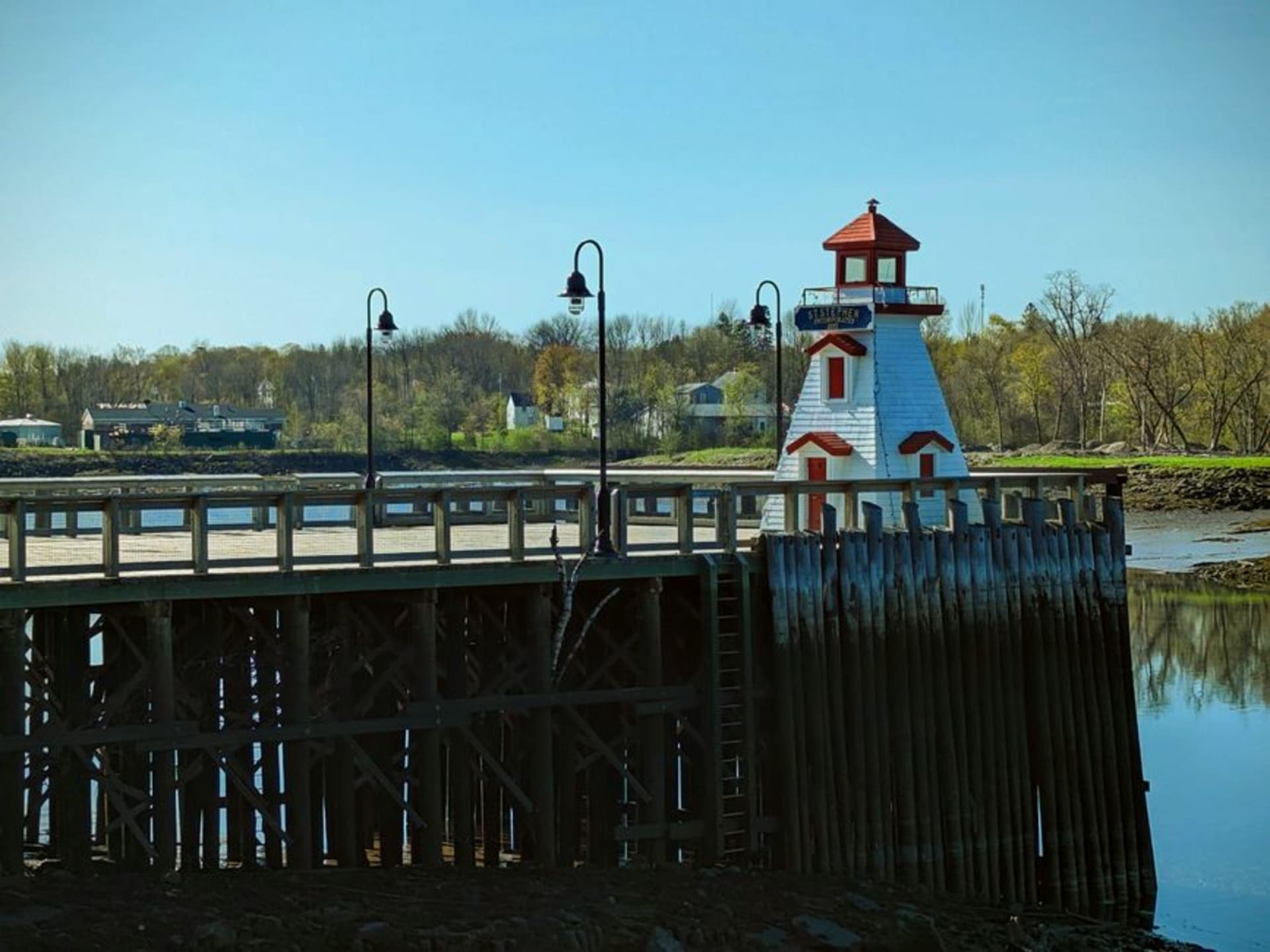 The Saint John River flowing past Fredericton's historic downtown skyline at dusk