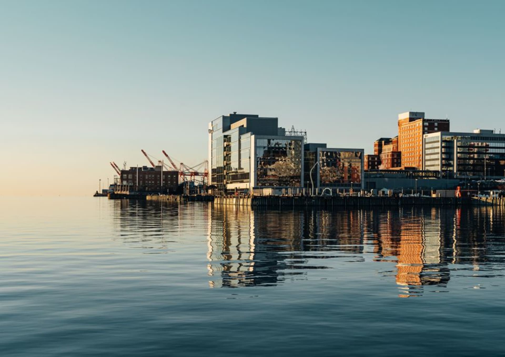 Halifax waterfront boardwalk with historic buildings and the harbour at dusk