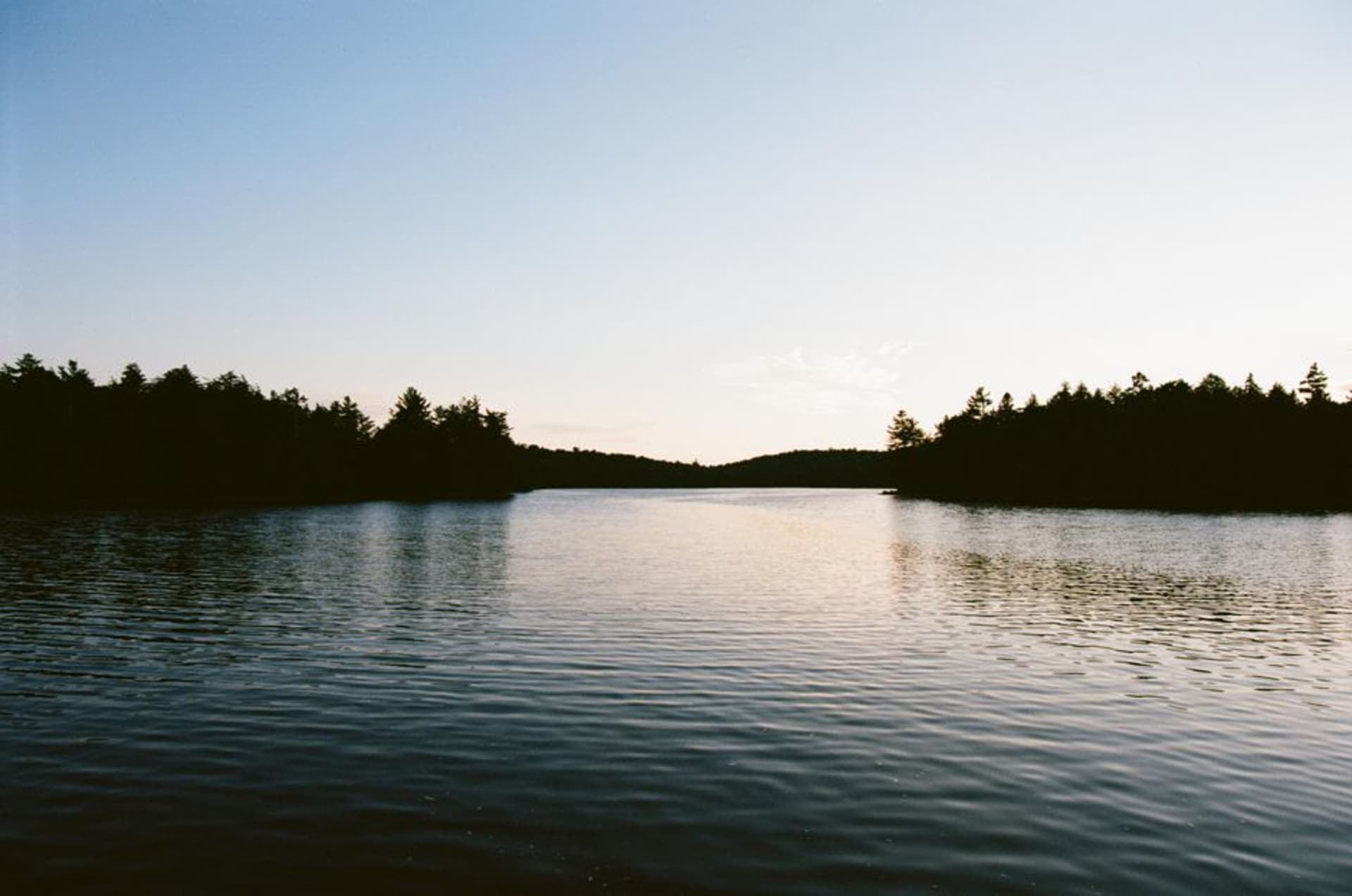 White quartzite ridge of the La Cloche Mountains reflected in a turquoise Killarney lake