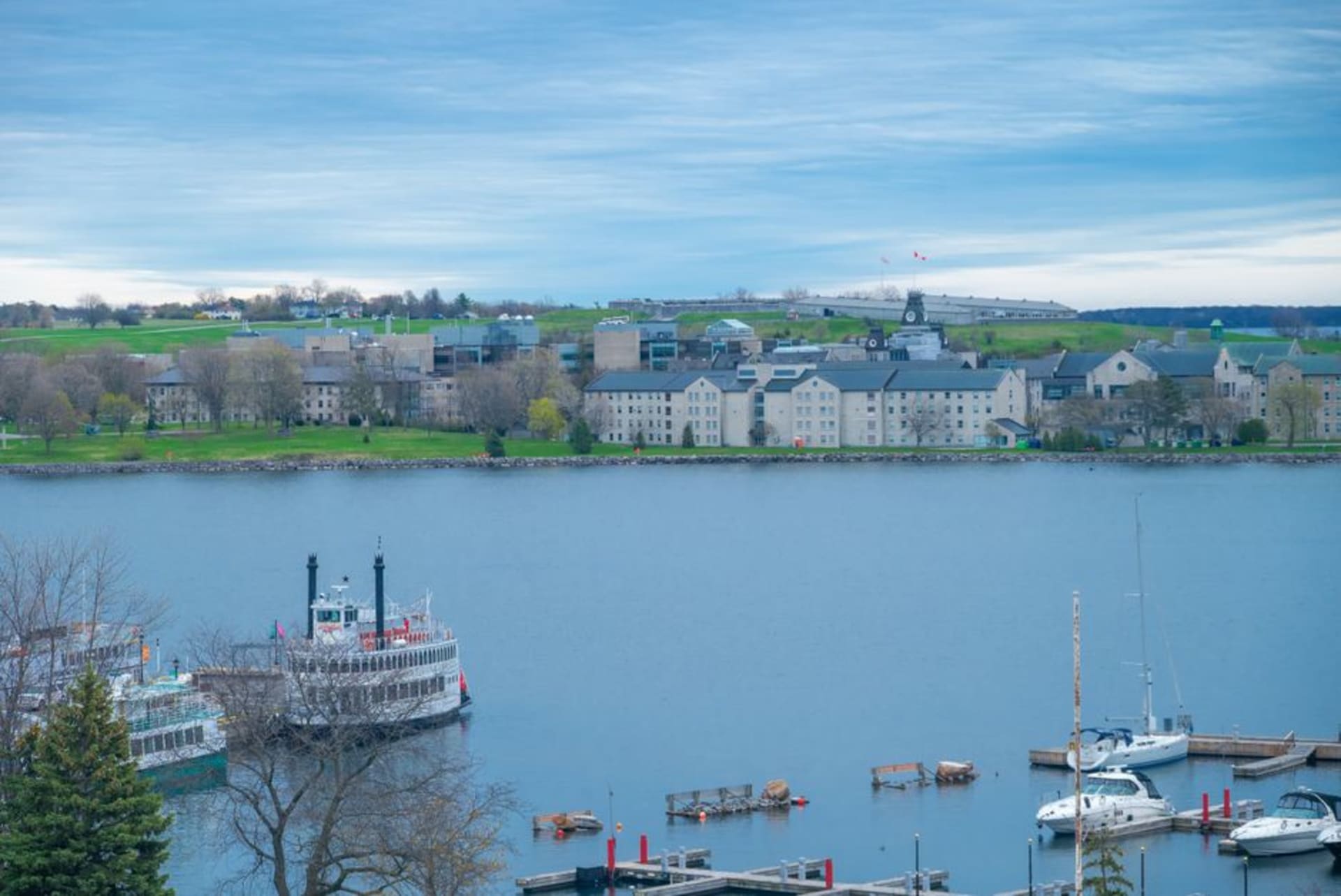 Limestone waterfront buildings of Kingston harbour with Fort Henry visible on the hill beyond
