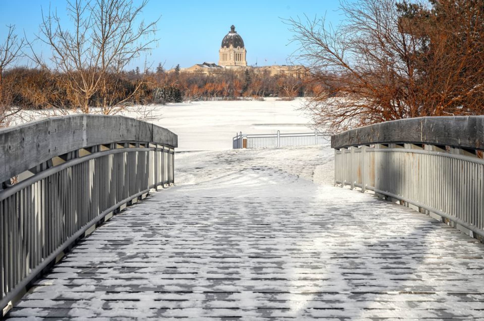 Wascana Centre lake reflecting the Saskatchewan Legislative Building at golden hour