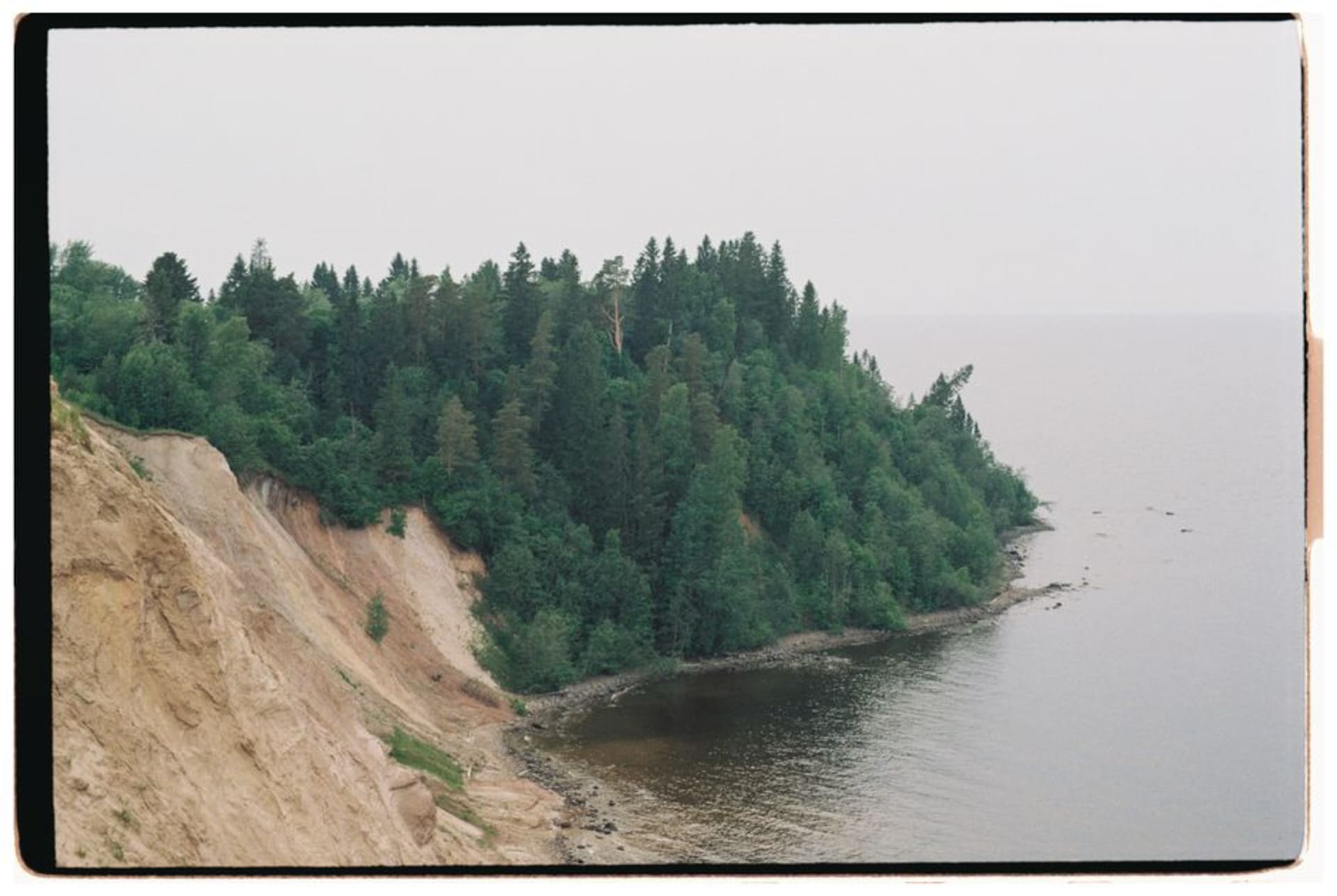 Dense boreal forest covering the Manitoba escarpment with Clear Lake visible below