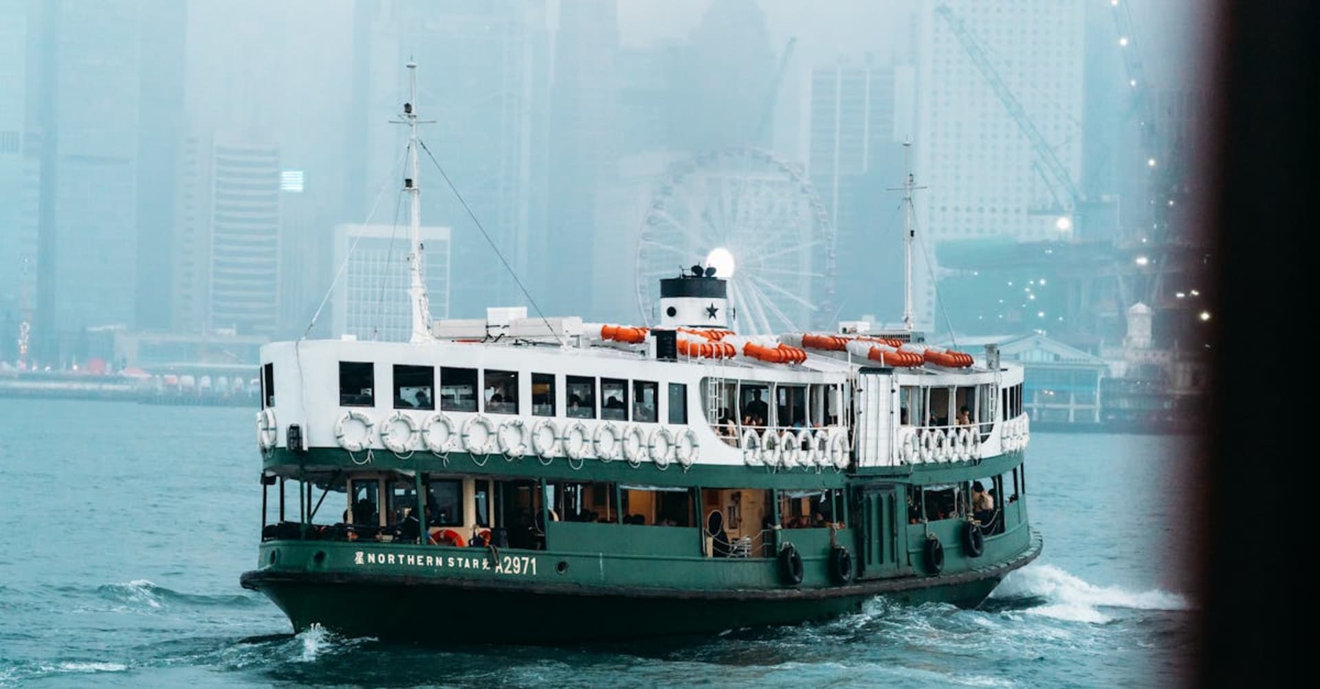 Hong Kong skyline at night viewed from Victoria Peak with harbour lights reflecting