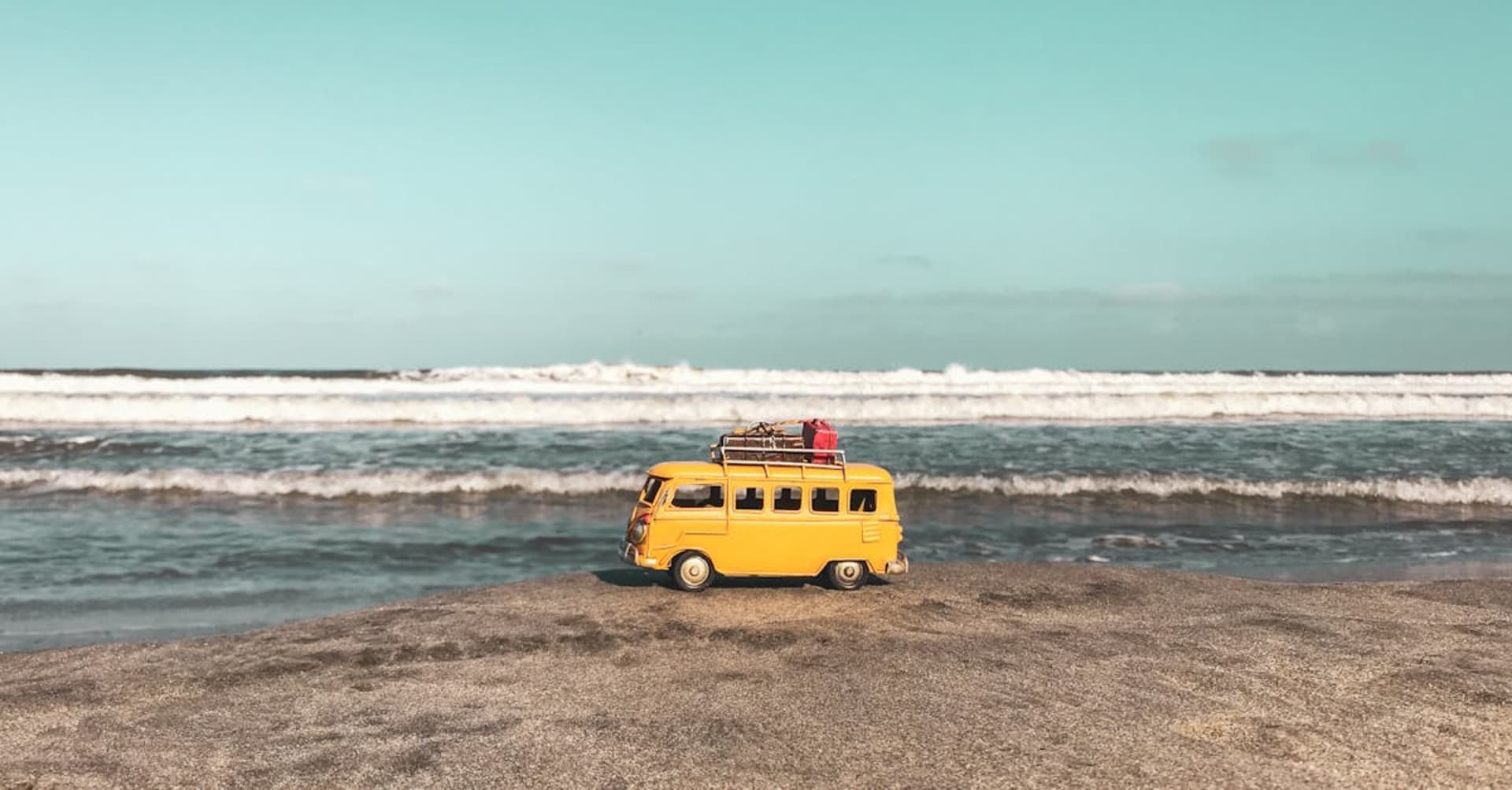 Colorful facades lining Salento's main street with green mountains behind