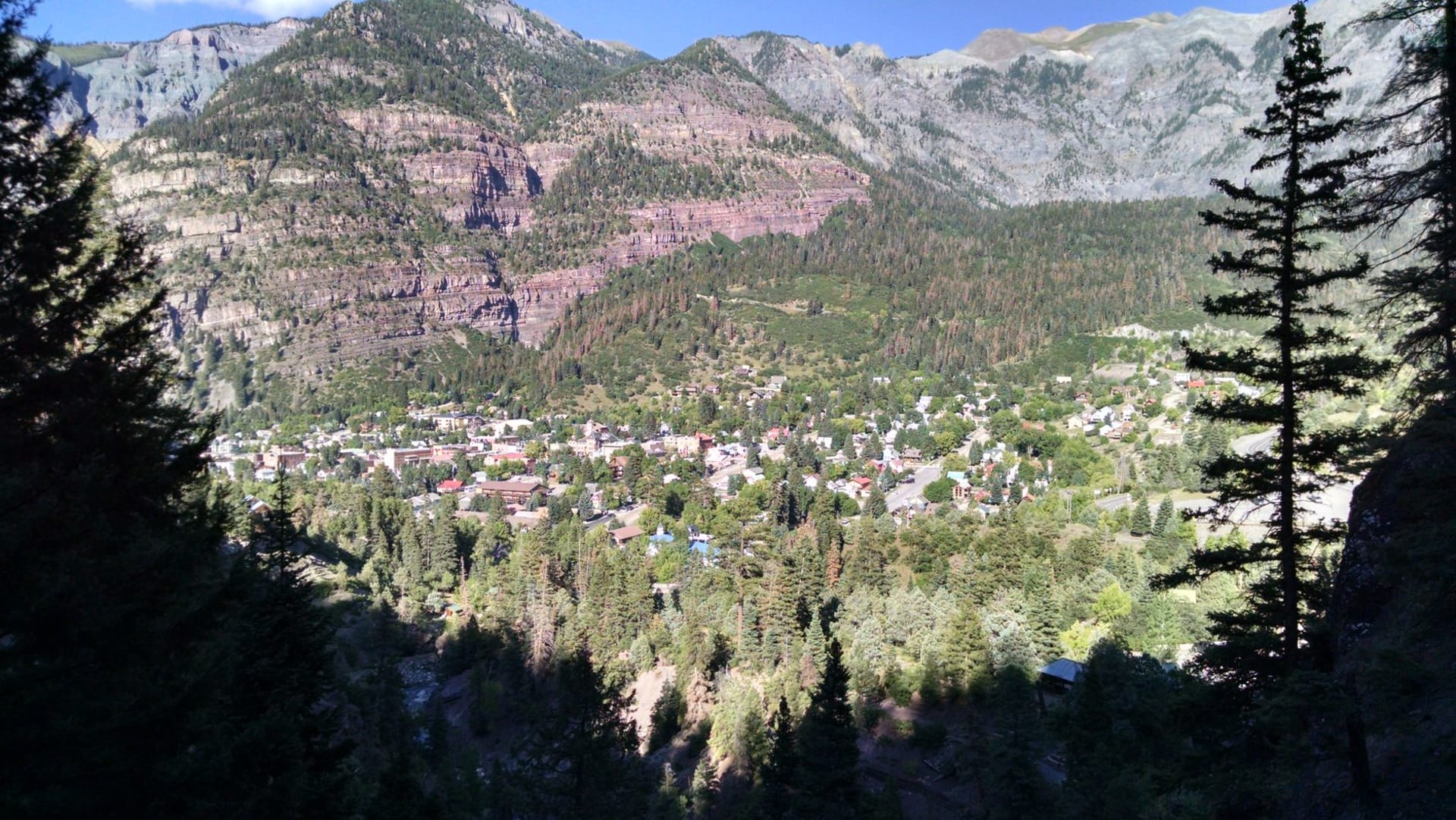 Ouray's small Victorian town set in its tight mountain bowl, surrounded by sheer canyon walls and peaks above nine thousand feet