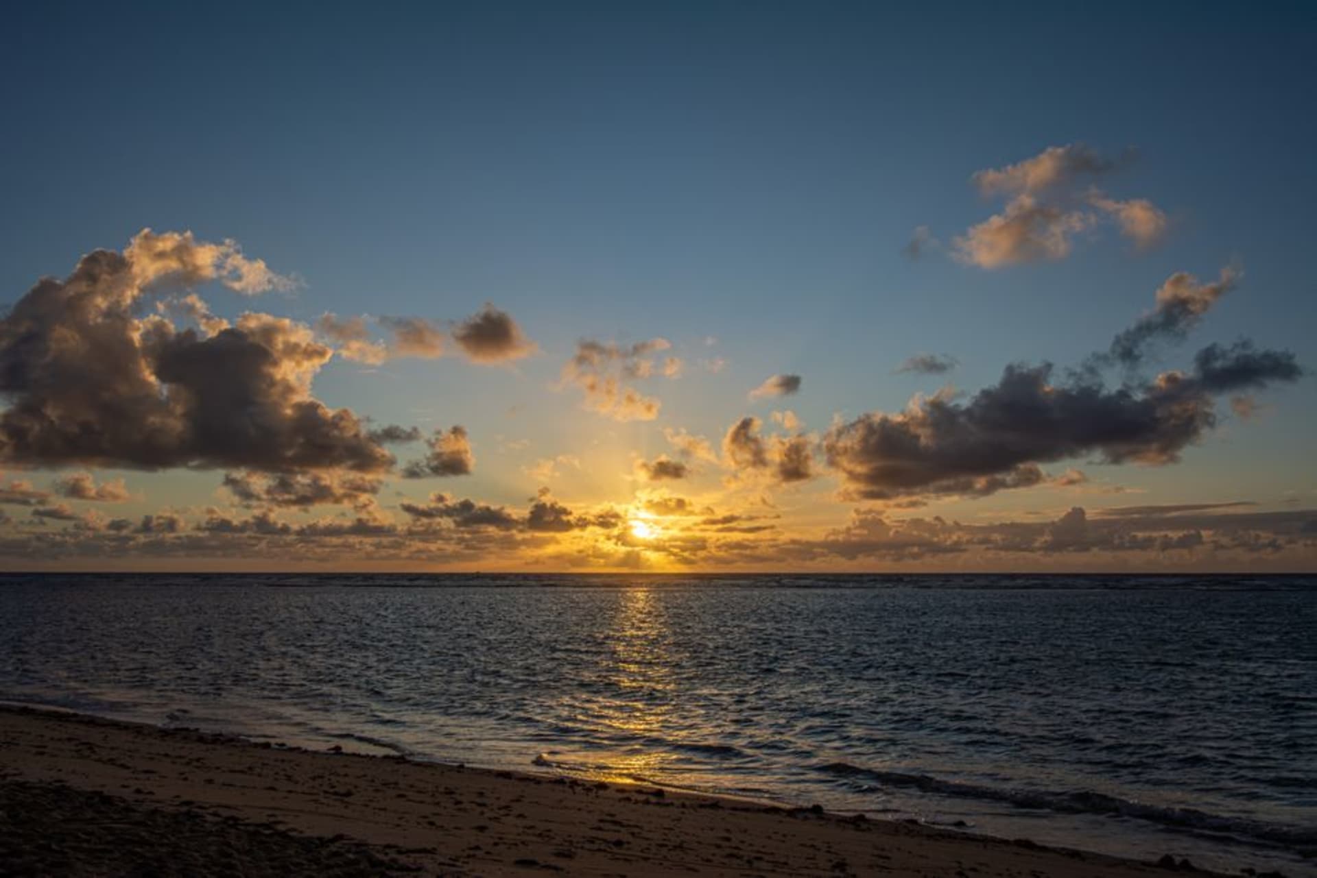 Calm shallow lagoon water and white sand at Titikaveka Beach on Rarotonga's south coast
