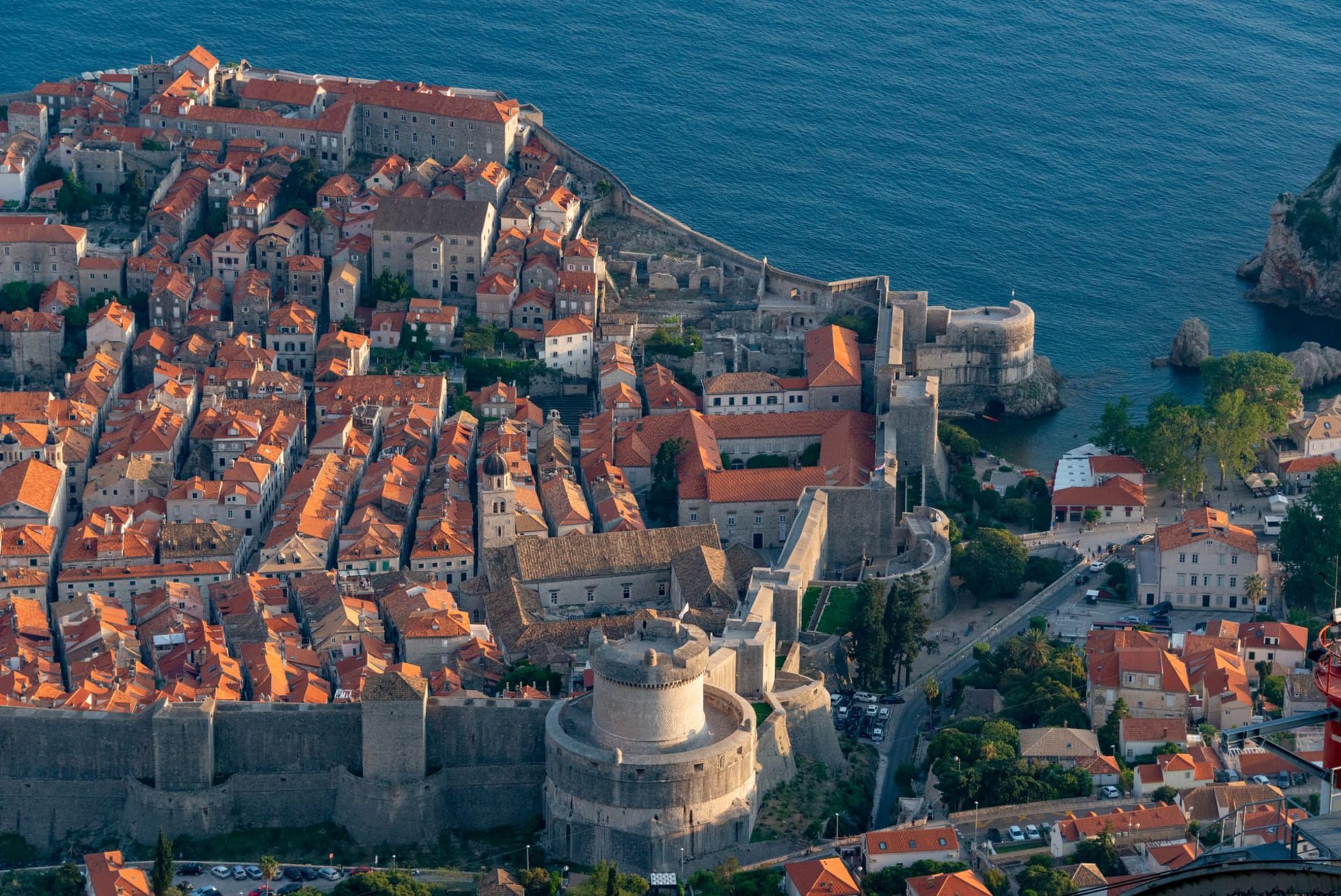 Dubrovnik's old city walls and orange rooftops above the glittering Adriatic at sunrise