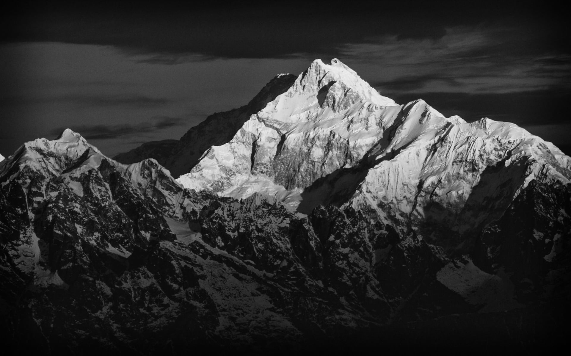 Snow-capped Kanchenjunga peak rising dramatically above Darjeeling in a black and white photograph