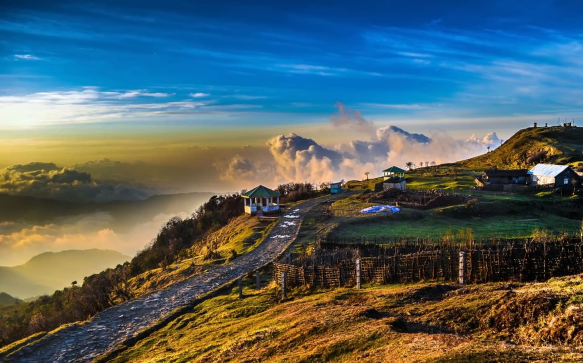 The ridge trail of Singalila National Park with prayer flags and distant Himalayan peaks
