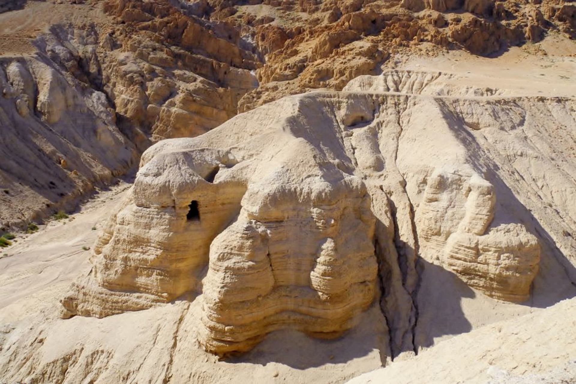 Sheer cliffs of the Judean Desert dropping toward the Dead Sea at Metzoke Dragot, canyon trails visible cutting through the rock