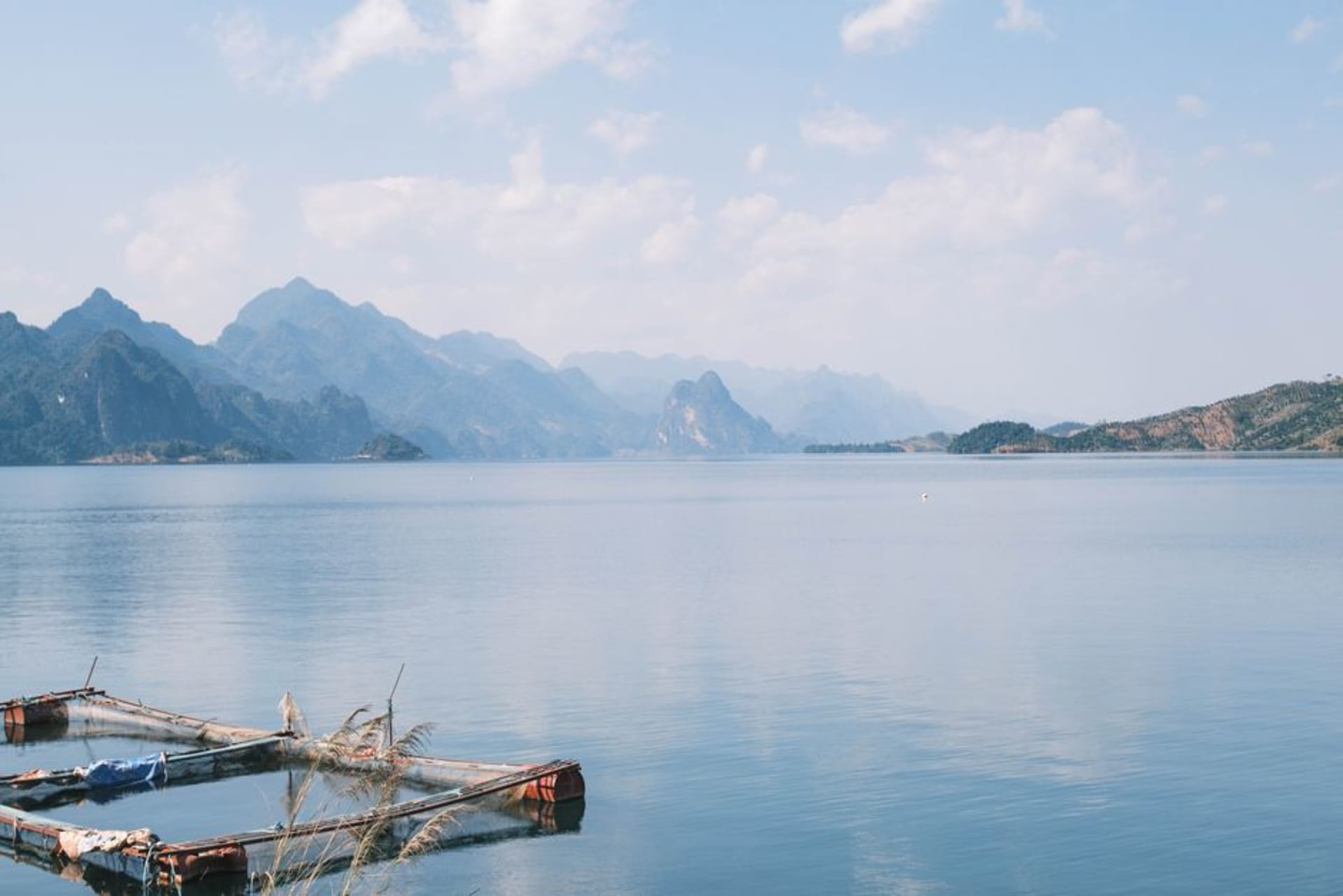 Freshwater Lake surrounded by misty green mountains with clouds settling low over the water