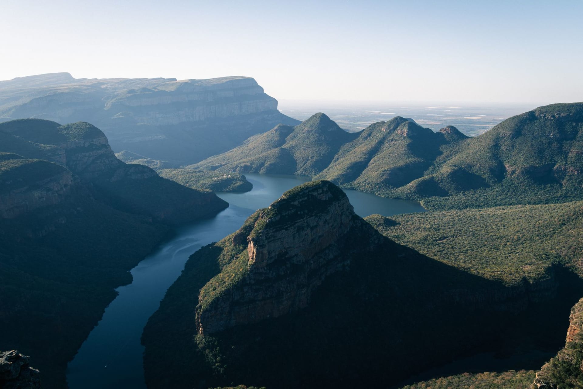 Cathkin Peak and the Champagne Castle massif reflected in a farm dam in late afternoon golden light