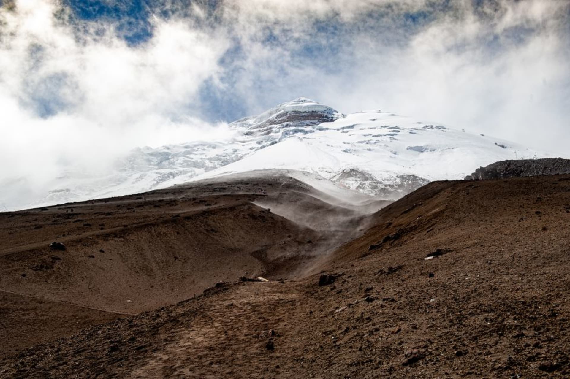 The glaciated, eroded crater walls of El Altar rising above the green Collanes valley inside Sangay National Park, Ecuador