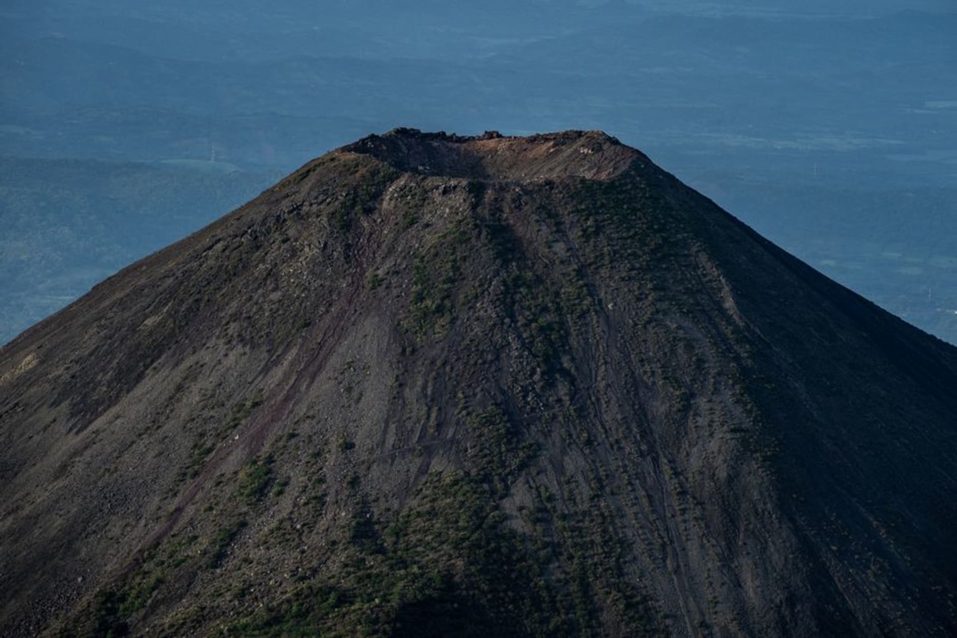 The perfectly symmetrical black cone of Izalco volcano seen from the Cerro Verde viewpoint in El Salvador