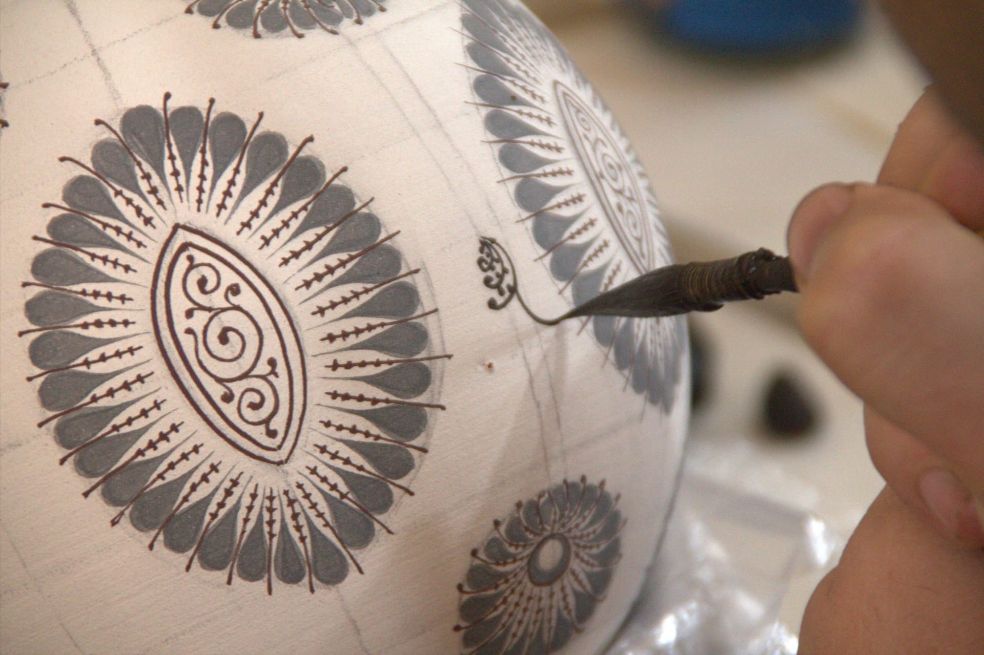Close-up of intricate hand-painted designs on Uzbek ceramics in Fergana, Uzbekistan
