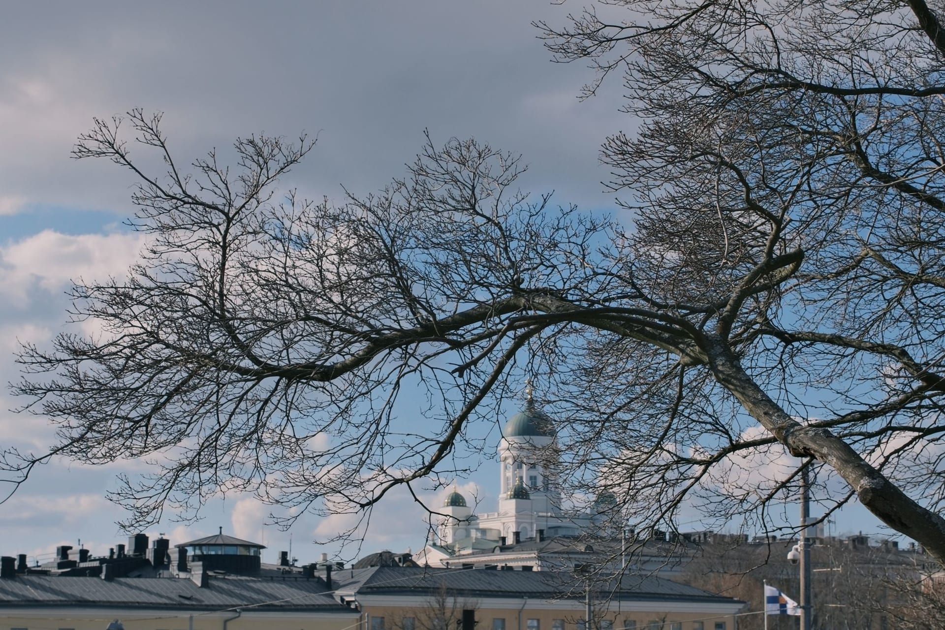 Helsinki's South Harbour at dawn, the pale neoclassical Cathedral dome rising above the market square and ferry boats moored along the waterfront