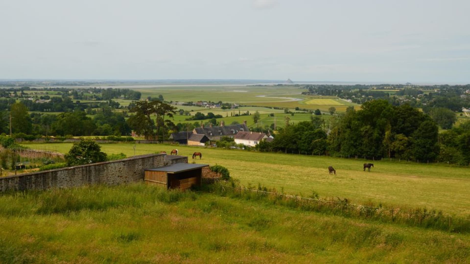 View from the Jardin des Plantes belvedere in Avranches over the bay toward the distant silhouette of Mont-Saint-Michel